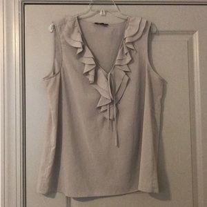 Cream colored top with ruffles